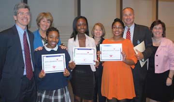 Pope John Paul II Catholic Academy students honored for service: (l-r):Library Director Tom Putnam, Columbia Campus Principal Claire Sheridan, Johanna Thermitus, Richelene Pierre, Lower Mills Principal Kim Mahoney, McKenzie Jeanette, Academy Regional Director Russ Wilson, Neponset Campus Principal Kate Brandley.